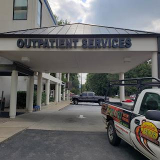 Entrance to a service building with parked vehicles.