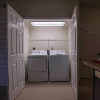 A compact laundry area with a washing machine and dryer inside a closet.