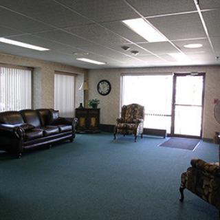 A spacious waiting room featuring comfortable seating and natural light.