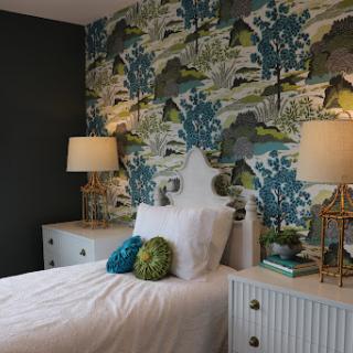 A beautifully designed bedroom featuring elegant wallpaper and stylish furnishings.