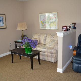 A cozy living room with a sofa, coffee table, and decorative elements.
