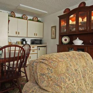 A cozy kitchen dining area with wooden furniture and decorative elements.