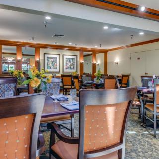 A well-decorated dining room with elegant furniture and ambient lighting.