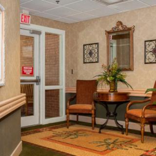 A cozy waiting area with chairs, a table, and decorative elements.