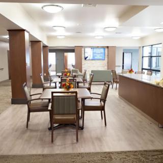 A modern and spacious dining area with neatly arranged tables and chairs.