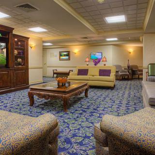 A cozy lounge area with comfortable sofas, a coffee table, and a television.