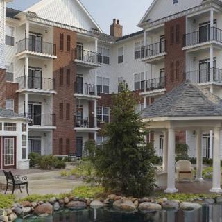 A modern apartment complex featuring balconies and landscaped outdoor areas.