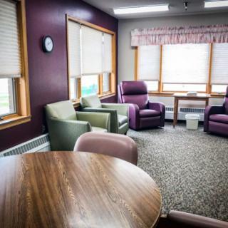 A cozy living room with comfortable chairs and ample natural light.