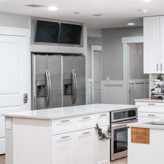 A modern kitchen with stainless steel appliances and a central island.
