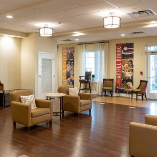 A modern lobby area with comfortable seating and wooden flooring.