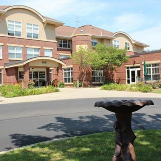 Exterior view of a residential building with landscaped gardens.