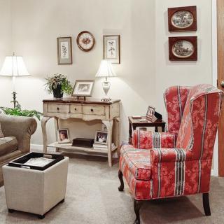 A cozy, elegantly decorated living room with classic furniture and warm lighting.