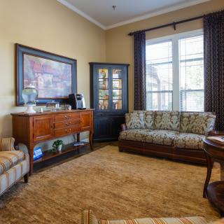 A cozy living room featuring comfortable seating and classic wooden furniture.