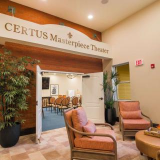 A cozy lobby with seating and a theater entrance labeled 'CERTUS Masterpiece Theater'.
