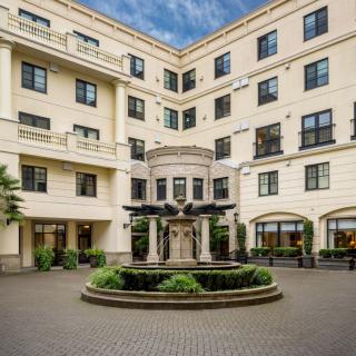 Elegant residential building with a central courtyard and fountain.