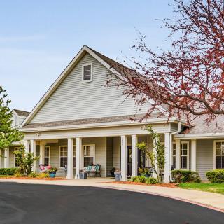 A residential building with a well-maintained exterior and landscaped surroundings.