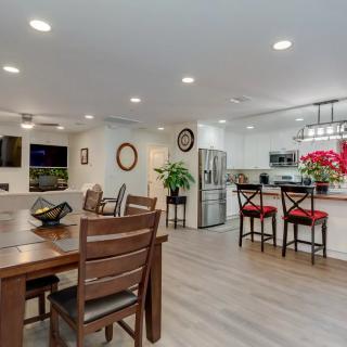 A spacious open-concept dining and kitchen area with modern decor and wooden flooring.
