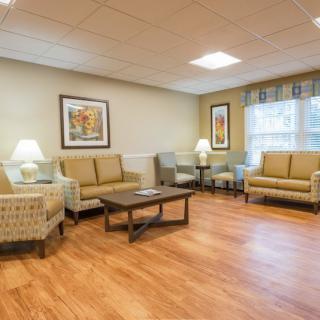 A cozy living room with sofas, chairs, a coffee table, and decorative elements.