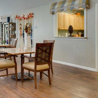 A cozy dining area with wooden furniture and decorative elements.