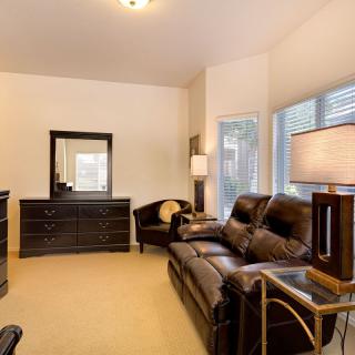 Cozy living room with leather seating and modern furniture.