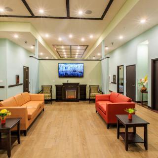 Modern lobby with colorful sofas and a large television.