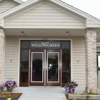 The welcoming entrance of WILLOWGREEN, adorned with beautiful flowers.