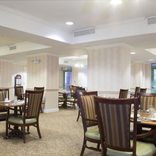 An empty dining area with neatly arranged tables and chairs.