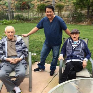 Three people enjoying a relaxing time outdoors in the garden.