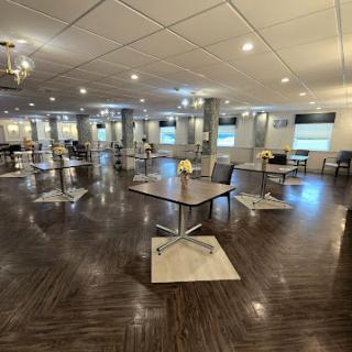 A spacious and modern interior with neatly arranged tables and chairs, reflecting a contemporary design.