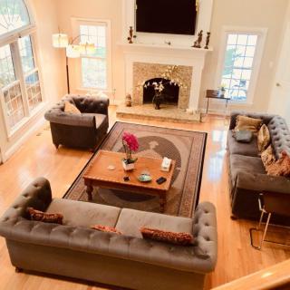 Spacious living room with elegant furniture and a fireplace.
