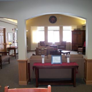A cozy lounge area featuring comfortable seating and ample natural light.