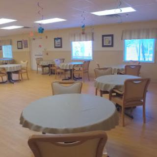 A spacious and inviting dining room with tables and chairs arranged for social gatherings.