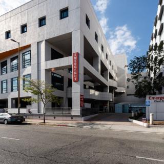 A view of a modern urban building on a city street during the day.