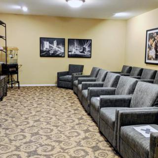 A cozy room with comfortable seating and artwork on the walls.