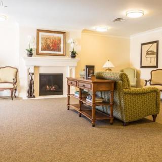 A cozy living room with comfortable seating and a warm fireplace.