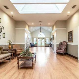 A spacious lobby area with comfortable seating and a skylight.