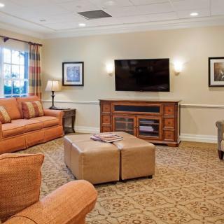 A cozy living room with comfortable seating and a large TV.