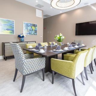 A modern dining room with a contemporary table setting and stylish furniture.