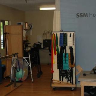 A physical therapy room equipped with various rehabilitation tools and exercise equipment.