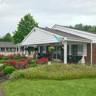 A suburban house with a beautifully maintained garden and lawn.