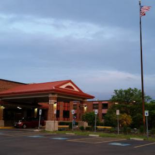 An inviting entrance to a hospitality establishment under a cloudy sky.
