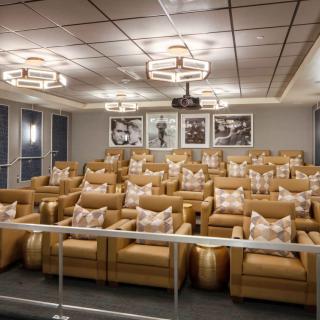 Luxurious home theater room with plush seating and elegant lighting.