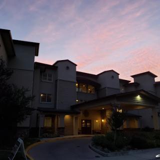 A beautifully lit building captures the serene colors of a sunset.