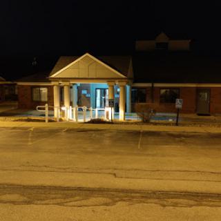 A brightly lit building at night, showcasing its architectural features.