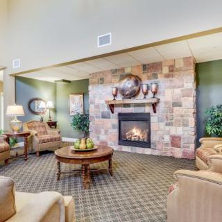A cozy living room featuring a fireplace with comfortable seating and elegant decor.
