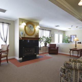 A cozy living room with a fireplace and comfortable seating.