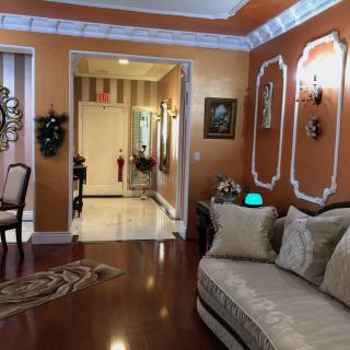 A luxurious living room with elegant decor and hardwood flooring.