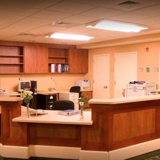 A well-organized reception area with a wooden desk and office equipment.