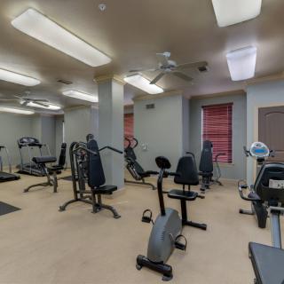 A well-equipped gym room with various exercise machines.