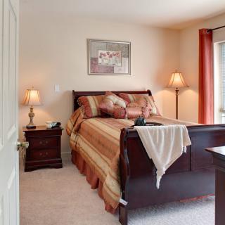 A cozy bedroom with warm colors and elegant furnishings.